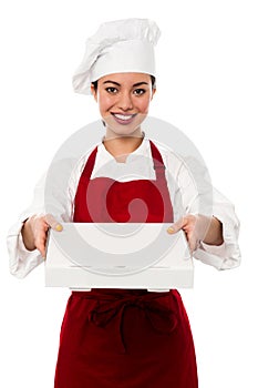 Attractive asian female chef delivering pizza