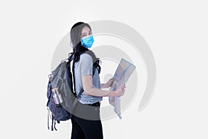 Attractive Asian female tourist Wear a mask to protect against Covid. Carry a backpack.