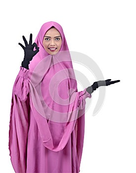 Attractive asian muslim woman showing empty space for copyspace