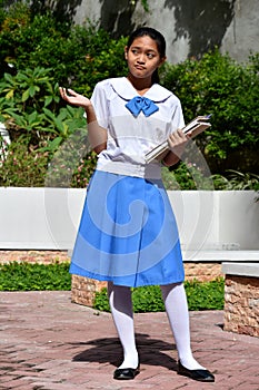 Undecided Cute Filipina Girl Student With School Books