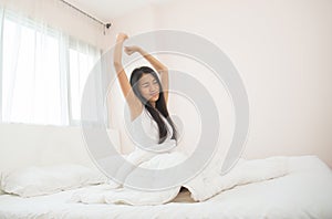 Attractive asian woman awaking on the bed & x28;sleep& x29; photo