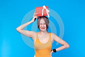 Attractive asian woman holding gift box in christmas, new year, valentine day, birthday celebration concept. Portrait of smiling