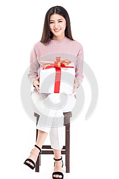Attractive asian woman holding gift box in christmas, new year, valentine day, birthday celebration concept. Portrait of smiling