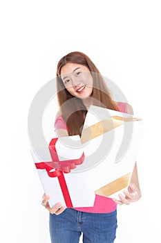 Attractive asian woman holding gift box in christmas, new year, valentine day, birthday celebration concept. Portrait of smiling