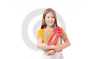 Attractive Asian woman holding gift box in christmas, new year, valentine day, birthday celebration concept. Portrait of smiling