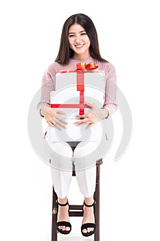 Attractive asian woman holding gift box in christmas, new year, valentine day, birthday celebration concept. Portrait of smiling