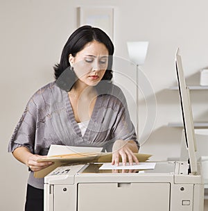 Attractive asian woman making copy.