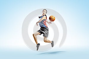 Attractive asian woman playing basketball