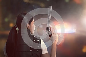 Attractive asian woman police with uniform with a guns