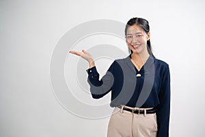 An attractive Asian woman is posing against a white studio background, and opening her palm