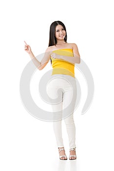 Attractive asian woman showing or introducing something