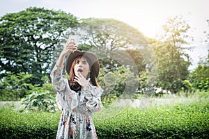 Attractive asian woman Take a photo and relaxing at the park