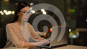 Attractive asian woman typing on laptop sitting in cafe with wifi, freelancer