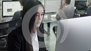 Attractive Asian Woman Working on Decktop Computer While Working in Big Open Space Office. Portrait of Positive Business