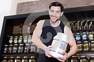 Attractive athletic man seller demostration sport nutrition photo