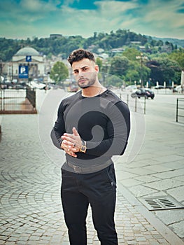 Attractive athletic man walking in city center in Europe
