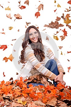 Attractive autumn woman and falling leaves