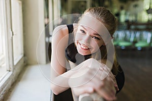 Attractive ballerina warming up in ballet class