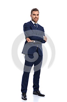 Attractive bearded guy in elegant suit crossing arms and smiling