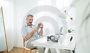 Attractive Bearded Mature adult male using smartphone