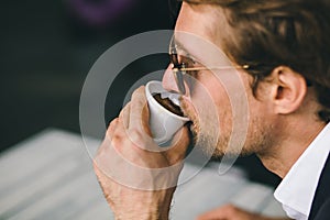 Attractive Bearded Young Guy Is Drinking Coffee Closeup Shot