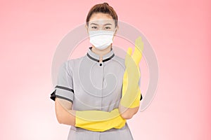 Attractive Beautiful Asian woman maid wearing face mask and gloves smile and open palm stop sign feeling so happiness and confiden