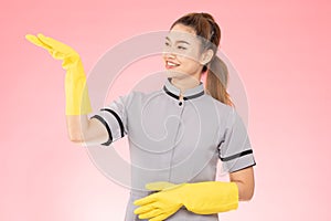 Attractive Beautiful Asian woman maid wearing gloves smile and open palm sign for display product