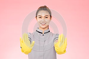 Attractive Beautiful Asian woman maid wearing gloves smile and open palm stop sign feeling so happiness