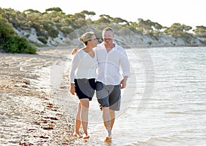 Attractive beautiful couple in love walking on the beach in romantic summer holidays