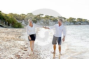 Attractive beautiful couple in love walking on the beach in romantic summer holidays