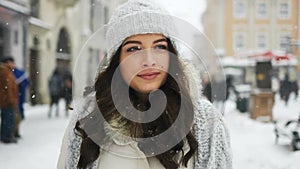 Attractive beautiful lady walking over snowy city background