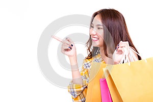 Attractive beautiful shopping woman point finger to copy space i