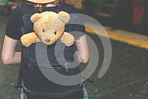 Attractive beautiful traveler woman is traveling alone with teddy bear. Charming beautiful woman always brings her favorite doll