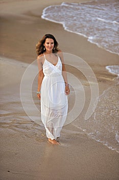 Attractive and beautiful woman enjoying vacation summer holidays at Spain coast village walking on beach