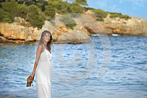 Attractive and beautiful woman enjoying vacation summer holidays at Spain coast village walking on beach