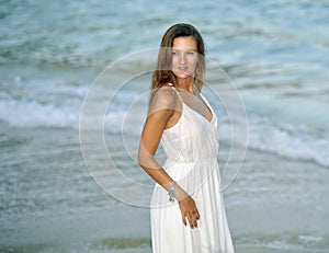 Attractive and beautiful woman enjoying vacation summer holidays at Spain coast village walking on beach