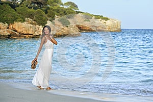 Attractive and beautiful woman enjoying vacation summer holidays at Spain coast village walking on beach