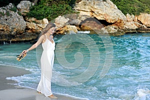 Attractive and beautiful woman enjoying vacation summer holidays at Spain coast village walking on beach