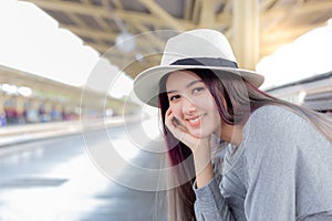 Attractive beautiful woman is waiting train for traveling around the city. photo