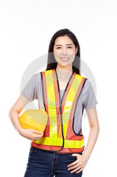 Attractive beautiful young asian construction female worker in yellow helmet and reflective vest posing isolated on white