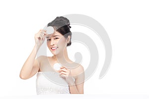 Attractive beauty young asian woman clean skin with cotton pad removing make up on isolated white background