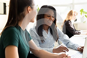 Attractive biracial and european coworkers working on common project