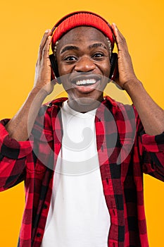 Attractive black american guy listening to music on headphones
