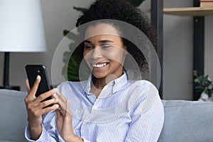 Attractive black gen z female communicate online using modern smartphone