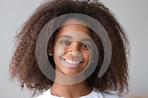 Attractive black teenager girl smiling looking at camera
