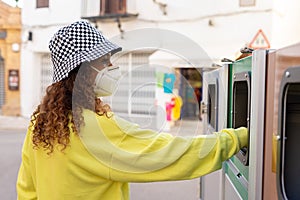 Attractive black woman with mask, recycling garbage
