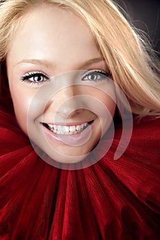 Attractive blond beauty in red theatrical jabot