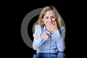 Attractive blond female laugh and point forward