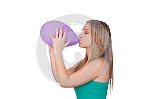 Attractive blond girl swelling a purple balloon