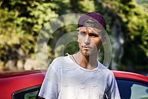 Attractive blond man next to his new stylish car